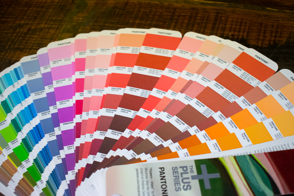 Pantone color book fanned out on the table